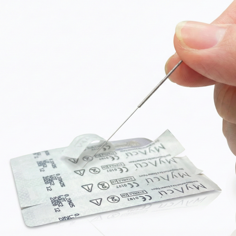 Hand holding a needle above a with MyAcu branding on a white background
